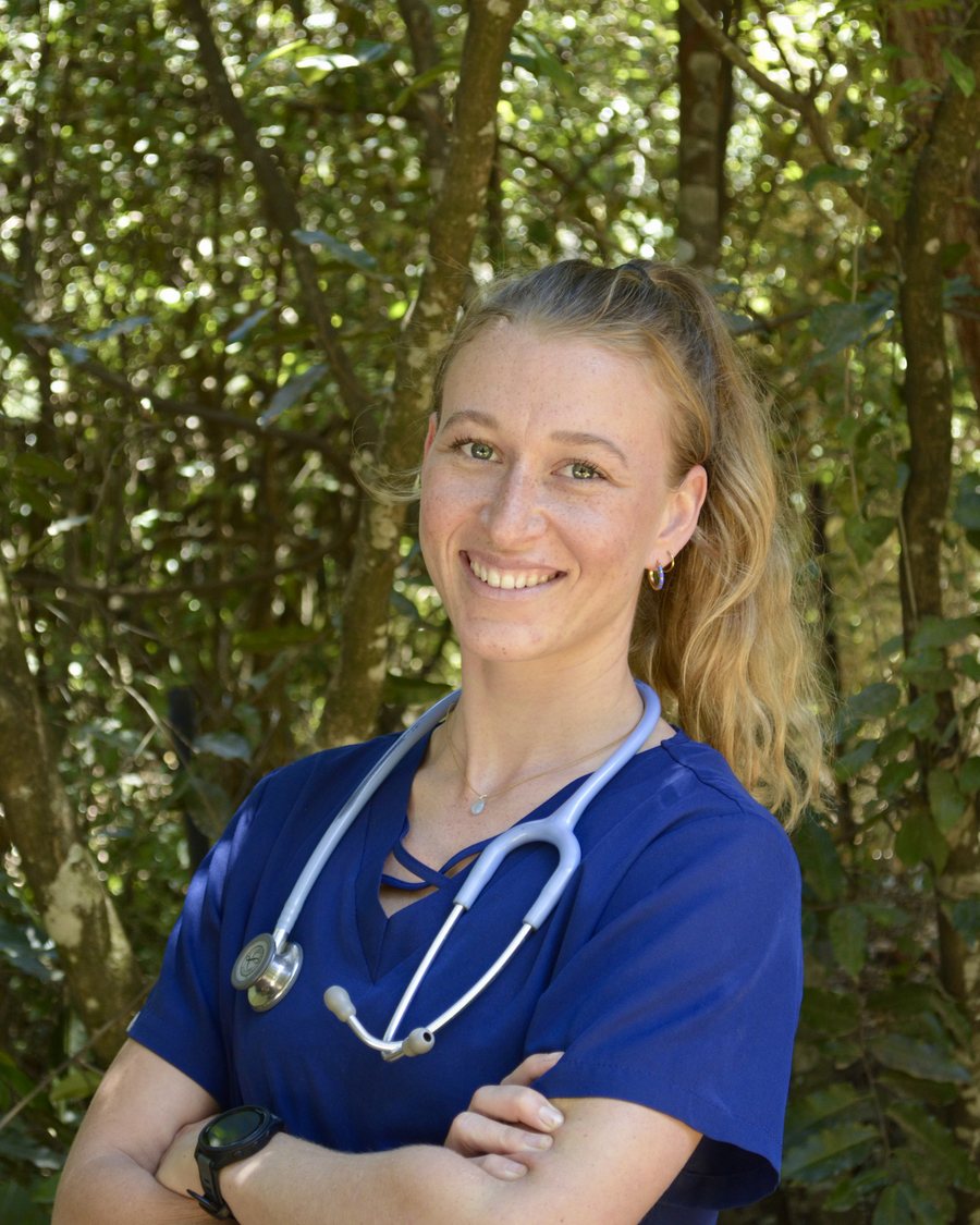 Isabel Heinel, Founder and Specialist Respiratory Physiotherapist, standing outdoors in scrubs with a stethoscope